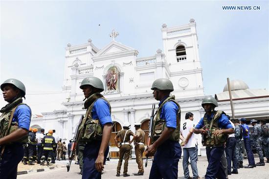 Security staff stand on guard outside the St. Anthony's Church where a blast took place in Colombo, Sri Lanka, April 21, 2019. (Xinhua/A.Hapuarachchi)